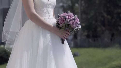 Bride Holding Wedding Bouquet in a Pretty Urban Garden
