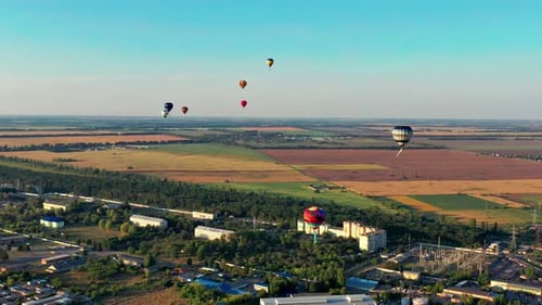 Beautiful balloons fly over the forest, park, city. Beautiful evening balloon flight.