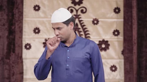 Man Coughing into Fist Looking Sick