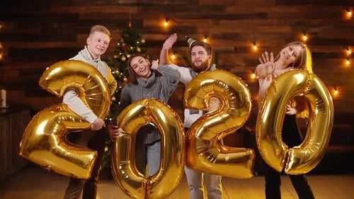 Friends Celebrating with Gold 2020 Balloons