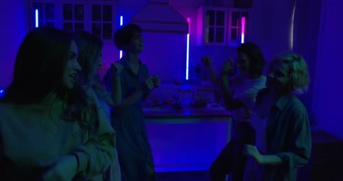 Friends Dancing at an Energetic Home Party