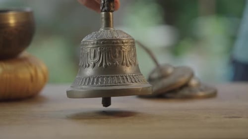 Hand Holding Decorative Tibetan Bell Close Up