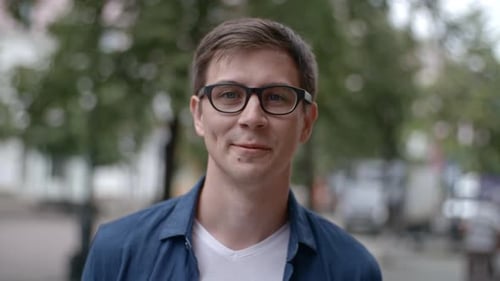 Young Man in Eyeglasses Smiling at Camera