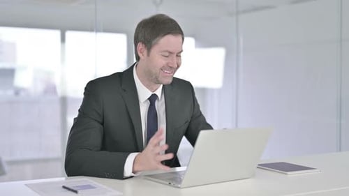 Man in Suit on Video Call in Office