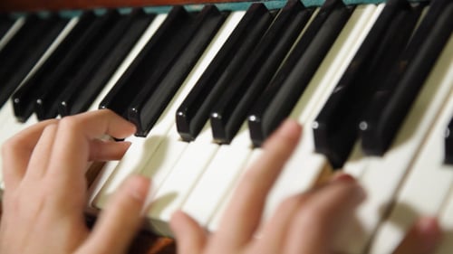 Hands Playing Piano in a Close Up View