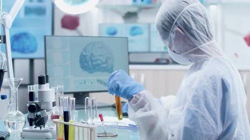 Scientist Works with Test Tubes in Bright Lab