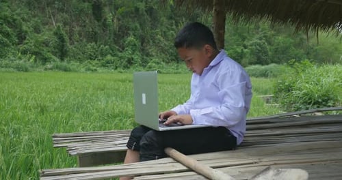 Poor Boy Using Laptop Computer