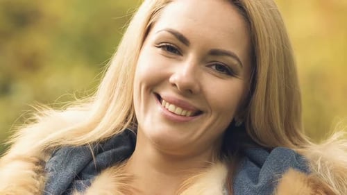 Beautiful Woman Smiling in a Fur Trim Jacket