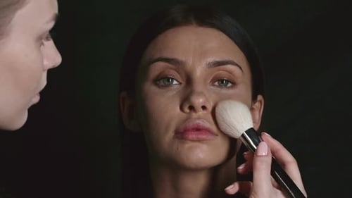Woman Having Makeup Applied by Artist