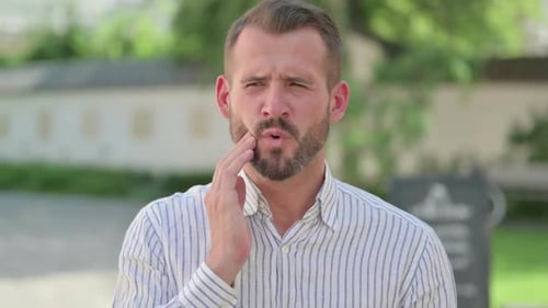 Man Massaging Sore Jaw, Toothache Pain
