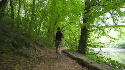 Man Running on Forest Path by Lake