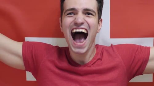 Excited Man Yelling and Holding Swiss Flag