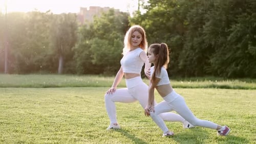 Woman and Child Stretching in Green Park