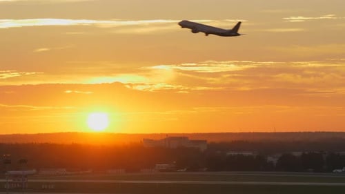 Plane Taking Off at Sunset