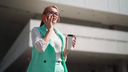 Young Businesswoman Talking on Phone in City Setting
