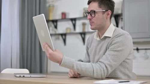 Online Video Chat on Tablet By Young Man