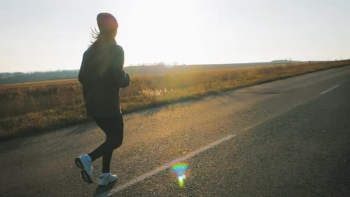 Young Fitness Woman Runner Athlete Running at Road