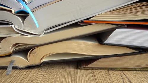 Stack of Many Books Open on Top of Each Other