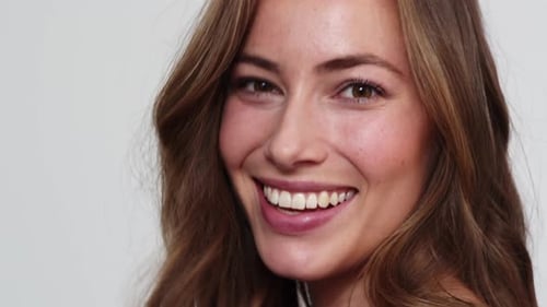 Smiling Woman with Auburn Hair in Studio Close-up