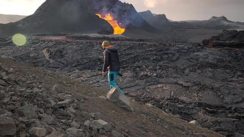 Photographer In Landscape With Lava Erupting From Fagradalsfjall Volcano