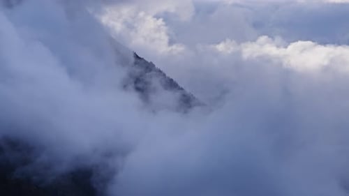 Thick clouds covering mountain peak
