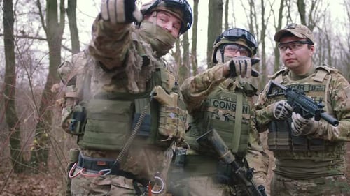 Group of Armed Young Soldiers in a Zone of Armed Conflict in Uniform Targeting with Assault Rifles