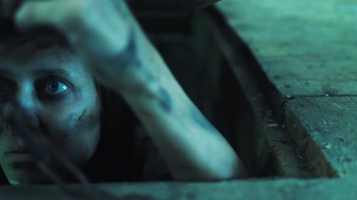 Woman Reaching Up from a Hole in the Floor