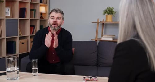 Crop View of Emotional Man Having Conversation with His Therapist in Office