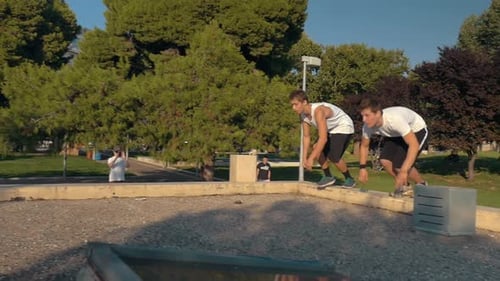 Young Men Practicing Parkour in City Park