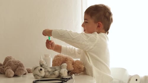 Boy Plays Doctor with Teddy Bear at Home