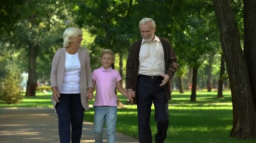 Little Boy and Grandparents Walking in Park, Weekend Visit, Happy Time Together