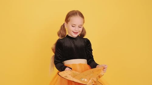 Little Blonde Girl in Witch Costume on Halloween at Orange Studio Background
