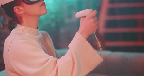 Woman Plays Game With Virtual Reality Headset
