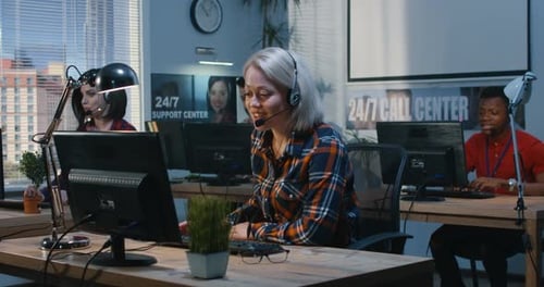 Office Workers at Their Desks in a Support Center