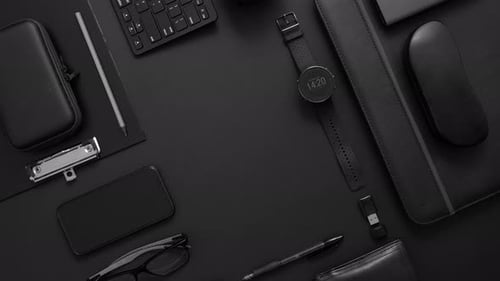 Business Concept. Flat Lay Composition with Various Black Gadgets on Dark Black Surface