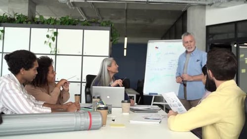 Office Team Discusses Graph at Meeting