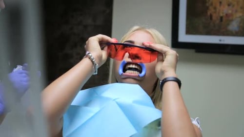 Teeth whitening procedure, dentist - Close-up of patient