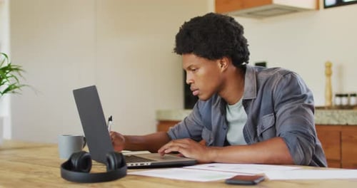 Man Working on Laptop at Home Office