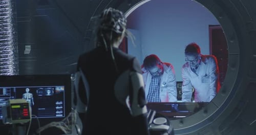 Scientists Study Woman Wearing Sensor Cap in Lab