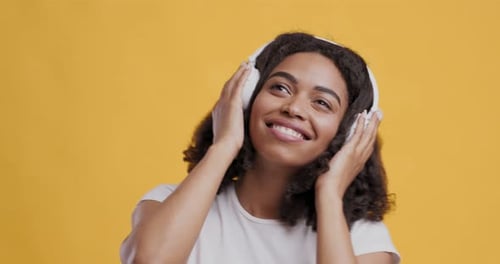 Smiling Woman Listening to Music on Headphones