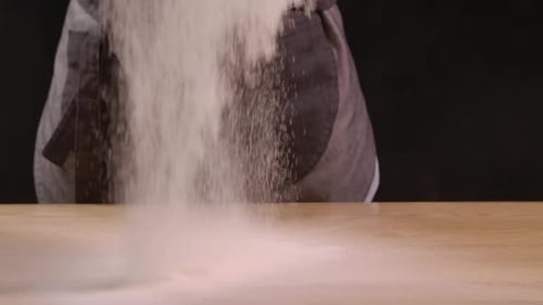 Flour Being Poured onto Wooden Surface
