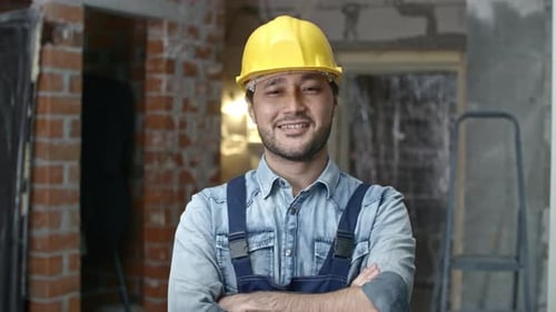Smiling Construction Worker Wearing Hard Hat in Building