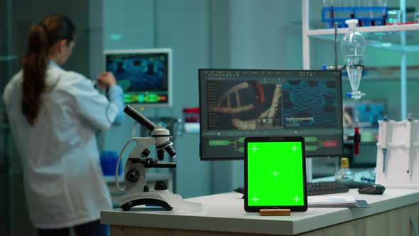 Team of Scientists Working in Background Using Tablet with Green Screen ...