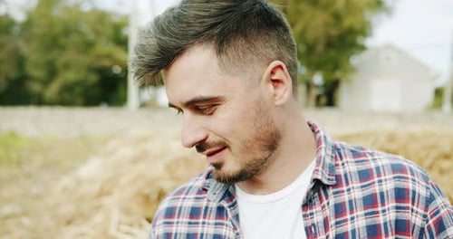 Man Farmer Working in the Field Inspects the Crop Wheat Germ Natural a Farming