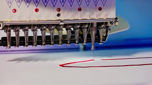 Embroidery Machine Stitching Red Design into Fabric