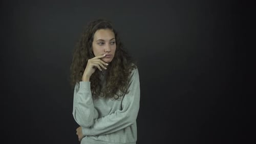 Woman Thinking with Hand on Chin in Studio