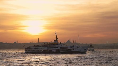Ferry Boat Cruises City Coastline at Sunset