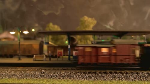 Close Up Model Steam Locomotive Moving Through Station.