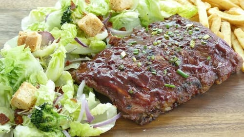 Barbeque Ribs with Salad and Fries Close Up