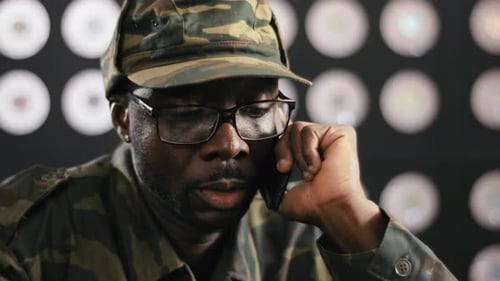Adult in Camo Hat Talking on Phone